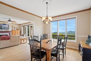 a dining room and living room with a table and chairs at Elderberry Escape in Beech Mountain
