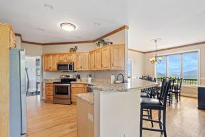 a kitchen with wooden cabinets and a table with chairs at Elderberry Escape in Beech Mountain