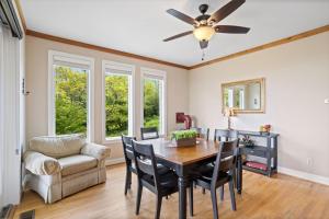 a dining room with a table and chairs and a ceiling fan at Elderberry Escape in Beech Mountain +23 photos