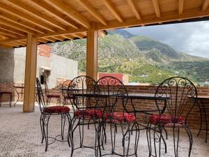 a group of chairs and a table on a patio at Riad Nassar in Chefchaouen