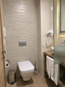 a small bathroom with a toilet and a sink at Vel-Mer Lefke in Ayios Nikolaos
