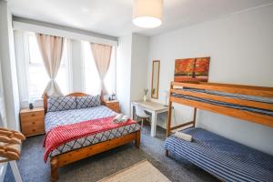 a bedroom with two bunk beds and a desk at Charming - 8ight Havens in Folkestone