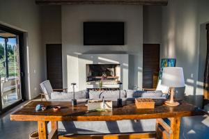 a living room with a couch and a table at Atamisque Wine Lodge - Valle de Uco in San José