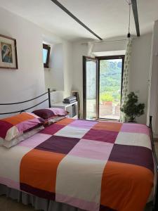 a bedroom with a large colorful bed with a window at Da Lucia in Francavilla al Mare
