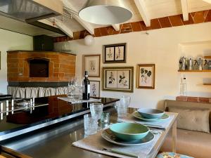 a kitchen with a table with bowls on it at Dimora 45, Contemporary Apartments in a Historic Building, Valdichiana, Tuscany in Sinalunga +40 photos