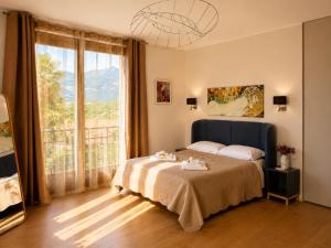 a bedroom with a bed and a large window at Villa La Perla, Bellagio in Bellagio +49 photos