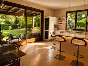 a kitchen with two bar stools and a counter with a table at Villa La Perla, Bellagio in Bellagio