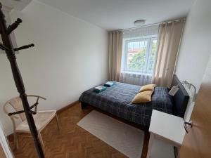 a small bedroom with a bed and a window at Old Town Apartment in Võru