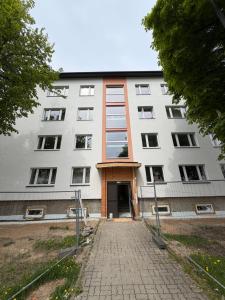 a large white building with a door at Old Town Apartment in Võru