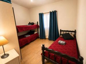 a bedroom with a bed with a red comforter at Hospedaje Don Felipe in Belén +1 photo