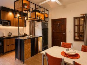 a kitchen with a table and a refrigerator at Hospedaje Don Felipe in Belén