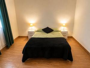 a bedroom with a large bed with two night stands at Hospedaje Don Felipe in Belén