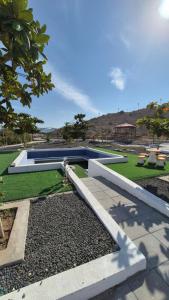 a swimming pool in a yard with grass and trees at Jory Hatta Resort - منتجع جوري حتا in Hatta