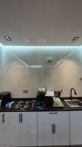 a kitchen with a sink and a stove top oven at Jory Hatta Resort - منتجع جوري حتا in Hatta