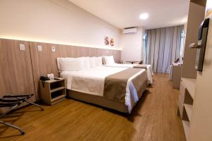 a hotel room with a large bed and a television at Hotel da Costa By Nobile in Aracaju +164 photos
