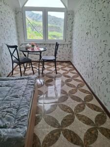 a room with a table and chairs and a table and a window at Адами Драхт in Garni