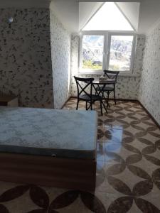 a bedroom with a bed and two chairs and a table at Адами Драхт in Garni +13 photos