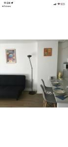a living room with a couch and a table at location studio traversant , lit King size,2 terrasses in Sausset-les-Pins