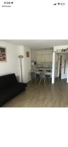 a living room with a couch and a table and chairs at location studio traversant , lit King size,2 terrasses in Sausset-les-Pins