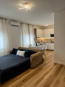 a living room with a bed and a kitchen at Iris home in Favaro Veneto