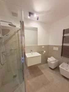 a bathroom with a shower and a sink and a toilet at Eva Urban Rooms Centro Lecco in Lecco +25 photos