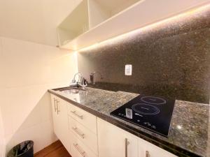 a kitchen with a sink and a counter top at Injoy Suítes & Aparts in Rio de Janeiro +55 photos