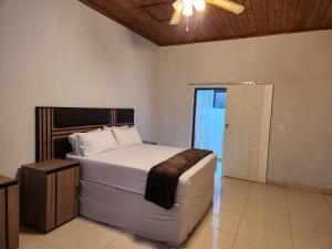 a bedroom with a bed and a ceiling fan at Mon Desir Estate - NR3 in Pietermaritzburg