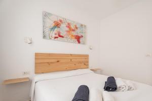 a bedroom with a bed and a painting on the wall at Villas 84 Est & Oest, Son Bou By MENORCARENTALS in Son Bou +29 photos