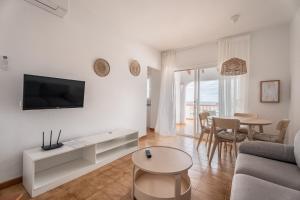 a living room with a couch and a table at Villas 84 Est & Oest, Son Bou By MENORCARENTALS in Son Bou