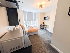 a bedroom with a bed and a tv in a room at The Marlowe in Southport