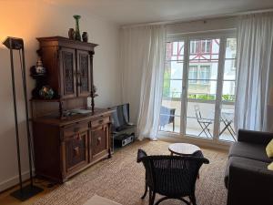 a living room with a large wooden cabinet and a television at Maison Mosgenstein in Bern