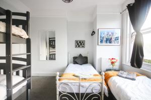 a bedroom with two bunk beds and a ladder at Aura - 8ight Havens in Folkestone +107 photos