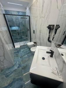a bathroom with a sink and a toilet at Costa blu in Agropoli +20 photos
