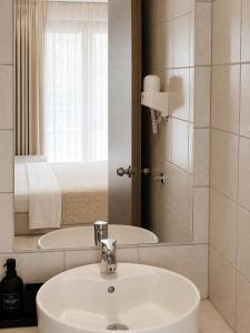 a bathroom with a sink and a mirror at Aelia Living in Stavros +32 photos