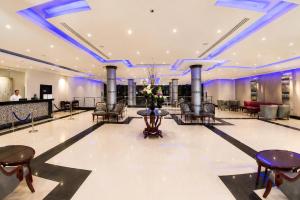 a lobby of a hotel with chairs and tables at Fun & Sun Naama Waves in Sharm El Sheikh +112 photos