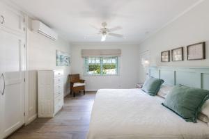 a bedroom with a bed and a ceiling fan at Southwinds - by ZenBreak in Saint Peter