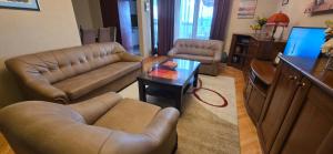 a living room with a couch and a table at Bar Central Point - 2BR Apartment in Bar