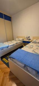 a room with two beds and a sink at Bar Central Point - 2BR Apartment in Bar