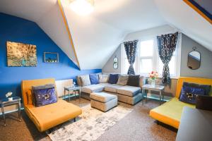 a large living room with a couch and chairs at Vibrant - 8ight Havens in Folkestone