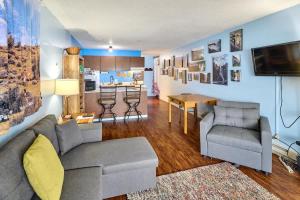 a living room with a couch and a kitchen at Lovely Oceanfront Condo -Top Floor - Pet Friendly in Lincoln City