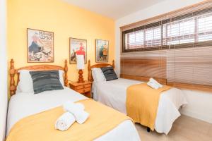 a bedroom with two beds and a window at Marvista - Bright Apt w Seaview, Pool in Sant Pere de Ribes +13 photos