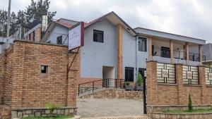 a brick building with a sign in front of it at Mansarda Park View Hotel in Nyagatare
