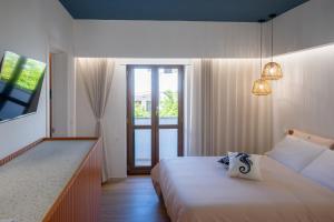a hotel room with a bed and a window at Vira Verso Est in Otranto