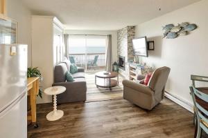a living room with a couch and chairs and a television at Oceanfront Condo - Second Floor - Pet Friendly in Lincoln City