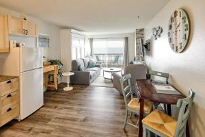 a kitchen and living room with a table and a refrigerator at Oceanfront Condo - Second Floor - Pet Friendly in Lincoln City +24 photos