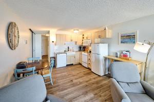 a living room with a couch and chairs and a kitchen at Oceanfront Condo - Second Floor - Pet Friendly in Lincoln City