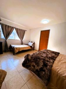 a bedroom with two beds in a room at HAUS EDELWEISS, Casa Quinta en Monte Grande, Bs As, EZEIZA AIRPORT, GARDEN, SWIMMING POOL in Monte Grande +82 photos