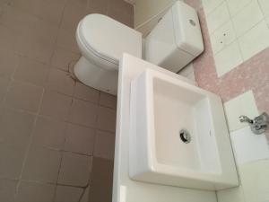 a bathroom with a toilet and a sink at Dephani Beach Hotel in Negombo