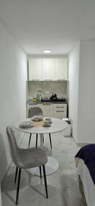 a kitchen with a table and chairs in a room at Airport Apartment Masa in Mitrovići