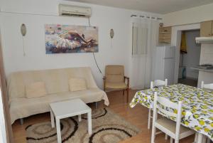 a living room with a couch and a table at Blagdan Holiday in Kukljica
